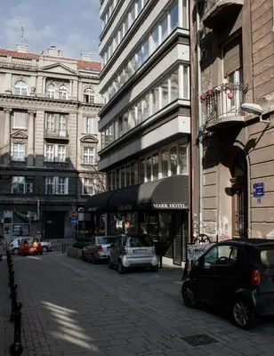 a city street with cars parked in front of buildings at MARK Hotel in Belgrade
