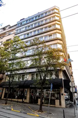 a large building on the corner of a street at MARK Hotel in Belgrade