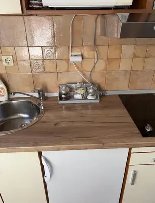 a small kitchen with a sink and a counter top at Garsonjera Zvezdara in Belgrade