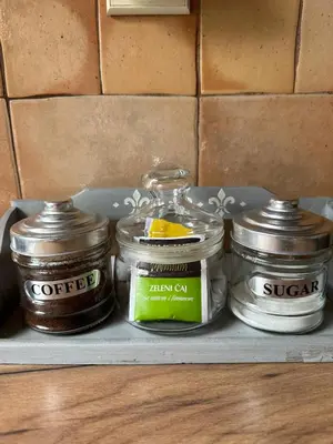 a shelf with four jars of food on it at Garsonjera Zvezdara in Belgrade