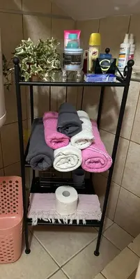 a shelf with towels and other items in a bathroom at Garsonjera Zvezdara in Belgrade