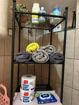 a black towel rack with some towels on it at Garsonjera Zvezdara in Belgrade