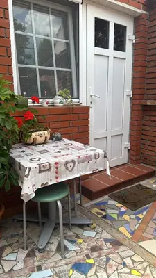 a table in front of a house with a door at Garsonjera Zvezdara in Belgrade