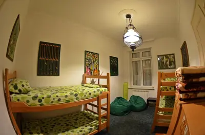 a bedroom with two bunk beds and a chandelier at Sun Hostel in Belgrade