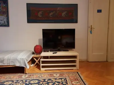 a living room with a flat screen tv on a table at Sun Hostel in Belgrade