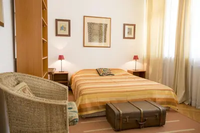 a bedroom with a bed and a suitcase at Sun Hostel in Belgrade