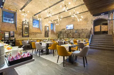 a restaurant with tables and chairs in a room at Marquise Hotel Garni in Belgrade
