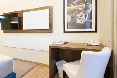 a hotel room with a desk and a tv at Marquise Hotel Garni in Belgrade