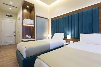 a hotel room with two beds and a window at Marquise Hotel Garni in Belgrade