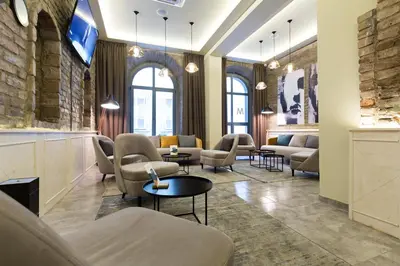a waiting room with couches and tables at Marquise Hotel Garni in Belgrade