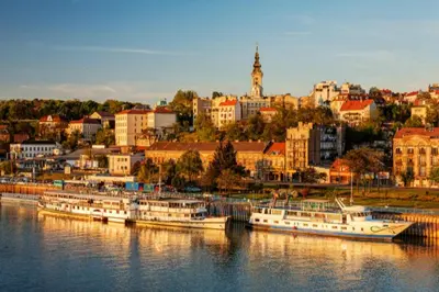 a group of boats docked in the water near a city at Marquise Hotel Garni in Belgrade