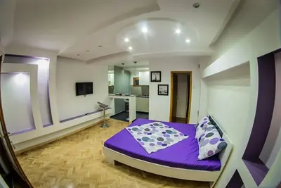 a bedroom with a purple bed in a room at Marmelo Loft in Belgrade