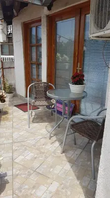 a patio with a table and chairs on a porch at Marmelo Loft in Belgrade