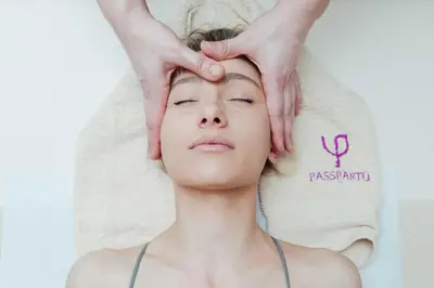 a woman getting her head groomed by a massage therapist at Hotel Passpartù Home Garni in Belgrade