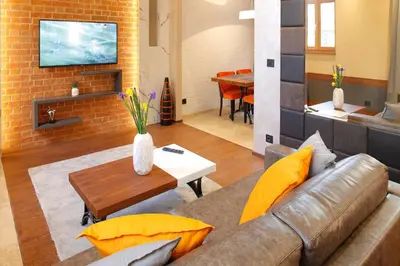 a living room with a couch and a table at Hotel Passpartù Home Garni in Belgrade