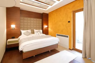 a bedroom with a large bed and a window at Hotel Passpartù Home Garni in Belgrade