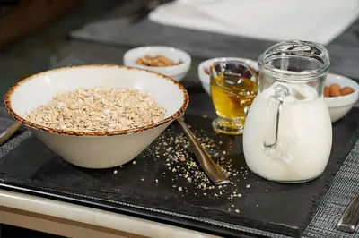 a tray with a bowl of oats and a glass of milk at Hotel Srbija Lux in Stara Pazova