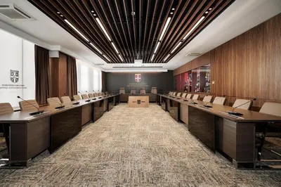 a conference room with rows of chairs and desks at Hotel Srbija Lux in Stara Pazova