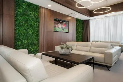 a waiting room with white furniture and a green wall at Hotel Srbija Lux in Stara Pazova