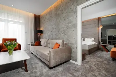a living room with a couch and a bed at Hotel Srbija Lux in Stara Pazova