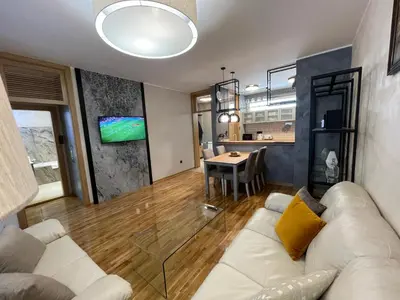 a living room with a couch and a table at Booky Apartment in Belgrade
