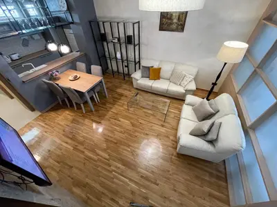an overhead view of a living room with a couch and a table at Booky Apartment in Belgrade