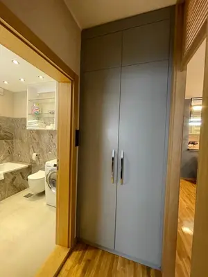 a bathroom with a large gray cabinet in a bathroom at Booky Apartment in Belgrade