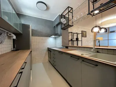 a large kitchen with a sink and a counter at Booky Apartment in Belgrade