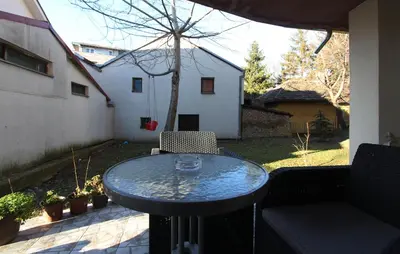 a table and a couch on a patio at Apartment Violet in Belgrade