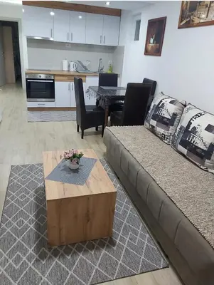 a living room with a couch and a table at Apartment Violet in Belgrade