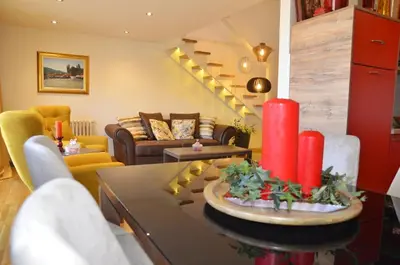 a living room with a red candle on a table at Apartment ON TOP 23 in Belgrade