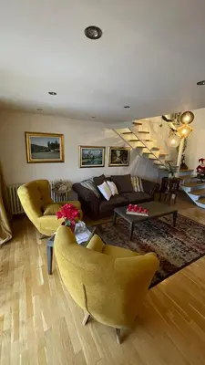 a living room with a couch and chairs and a table at Apartment ON TOP 23 in Belgrade