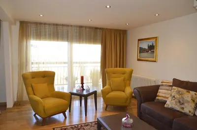 a living room with a couch and two chairs at Apartment ON TOP 23 in Belgrade