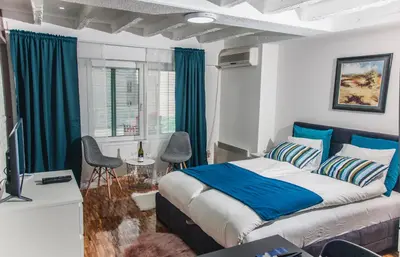 a bedroom with a bed and a table and chairs at Apartment Atelje Downtown in Belgrade