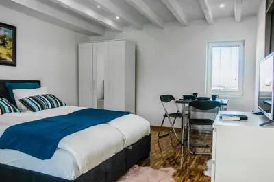 a bedroom with a bed and a desk with a computer at Apartment Atelje Downtown in Belgrade