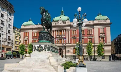 a statue in a plaza in front of a building at Apartment Atelje Downtown in Belgrade