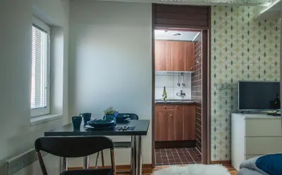 a kitchen with a table and two chairs in a room at Apartment Atelje Downtown in Belgrade