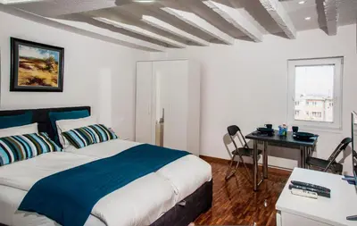 a bedroom with a bed and a desk with a computer at Apartment Atelje Downtown in Belgrade