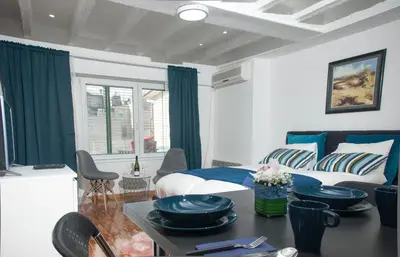 a bedroom with a bed and a table with dishes on it at Apartment Atelje Downtown in Belgrade
