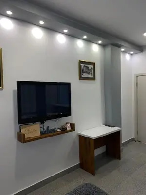 a large flat screen tv on a white wall at Rose Lux in Belgrade