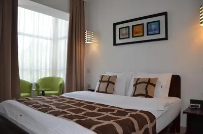 a hotel room with a bed and a window at Hotel Zeder Garni in Belgrade