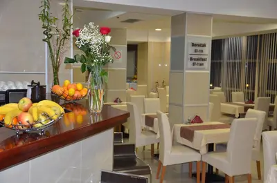 a lobby with a table with fruit and flowers on it at Hotel Zeder Garni in Belgrade