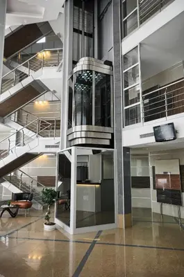 an office building with escalators and a lobby at Hotel Zeder Garni in Belgrade