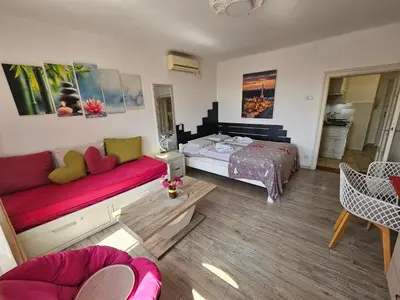 a living room with a bed and a couch at Matea apartman in Belgrade