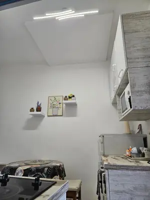 a kitchen with white walls and a stove top oven at Matea apartman in Belgrade