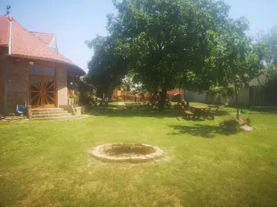 a backyard with a fire pit in the grass at CycloCamp & Hostel in Skorenovac