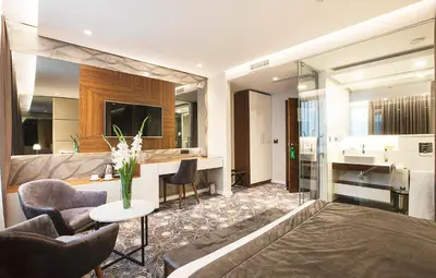 a living room with a couch and a table at Sky Hotel in Belgrade