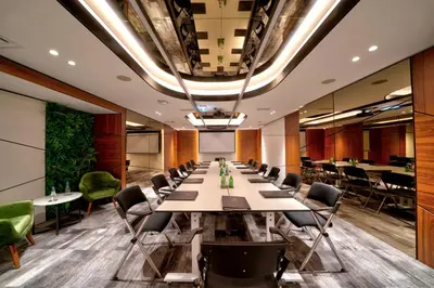 a conference room with a long table and chairs at Sky Hotel in Belgrade