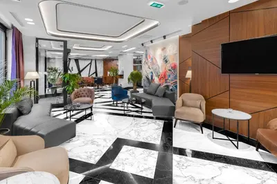 a lobby with couches and a flat screen tv at Sky Hotel in Belgrade