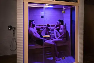 a man and two women sitting in a bath room at Sky Hotel in Belgrade